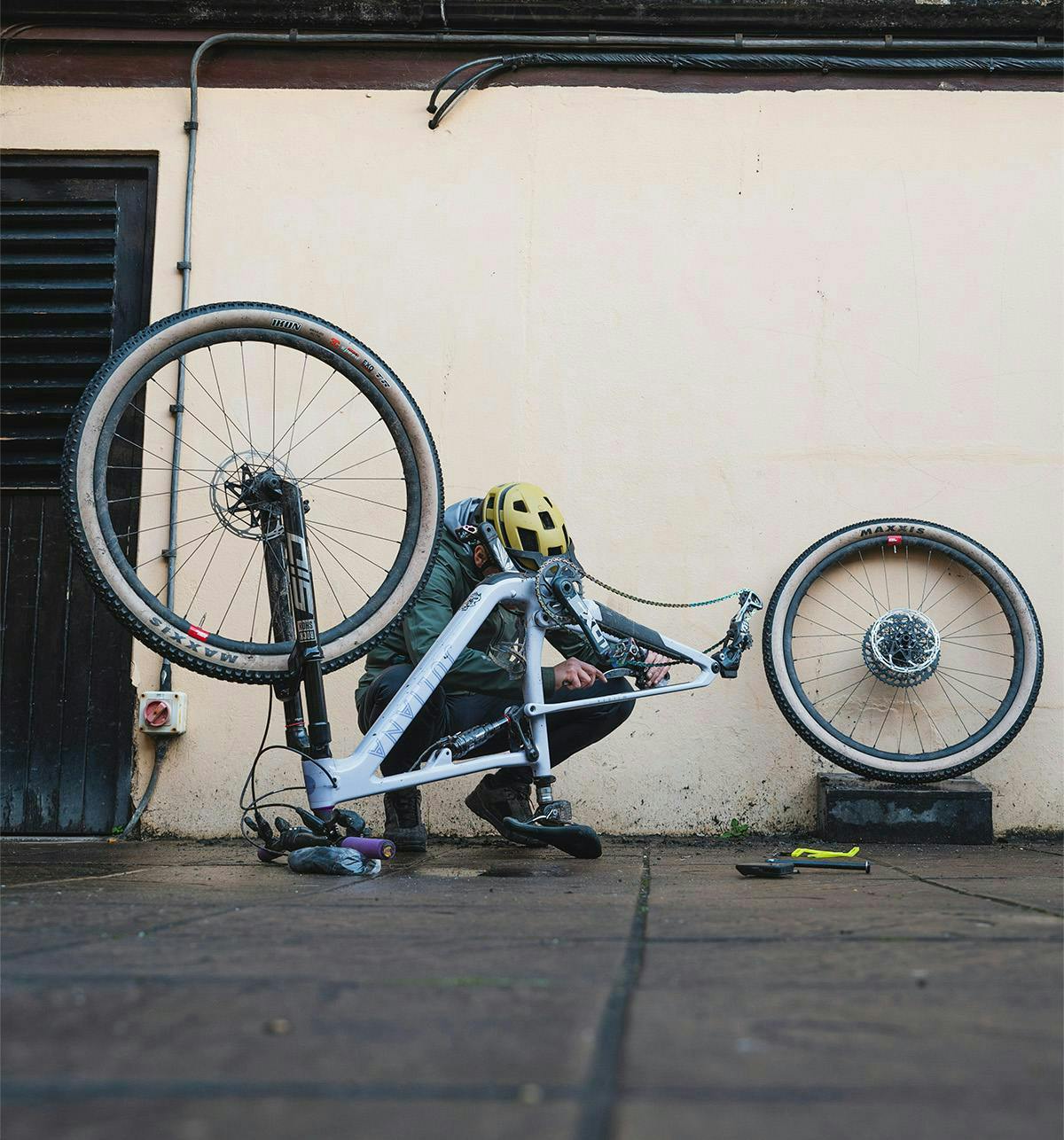 A Juliana Rider working on an upside-down Juliana Wilder XC full suspension mountain bike